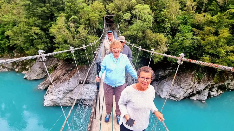 MoaTrek guests crossing the swing bridge over Blue Pools near Makarora