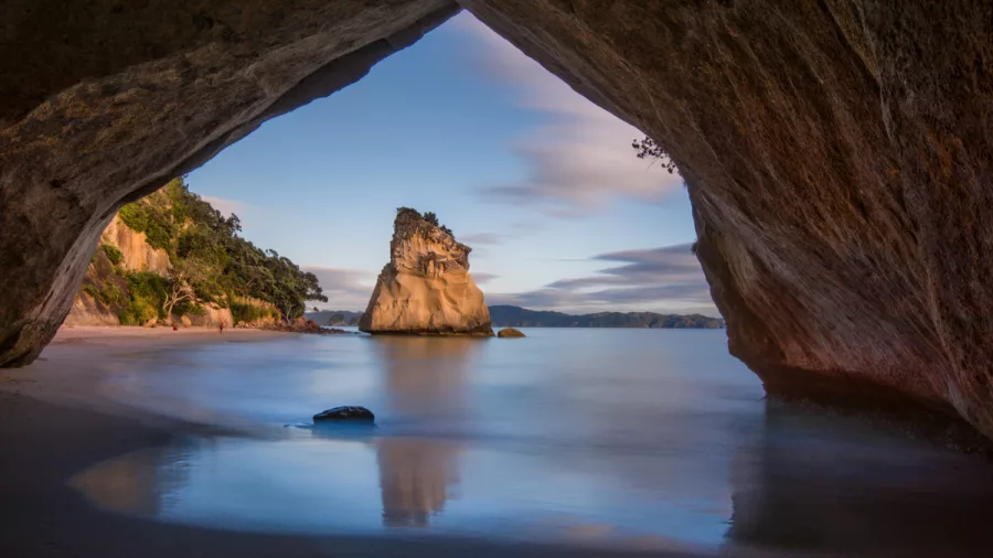 View of Cathedral Cove rock formation framed by cave entrance on Coromandel Peninsula