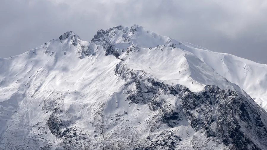 Close-up of a dramatic, snow-covered summit in the Southern Alps of New Zealand