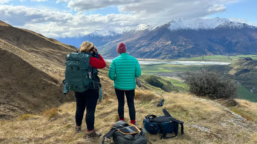 Photographers overlooking braided rivers in the Southern Alps, Mackenzie District