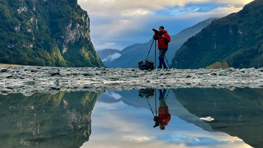 Photographer capturing mountain reflections in Aoraki Mount Cook National Park