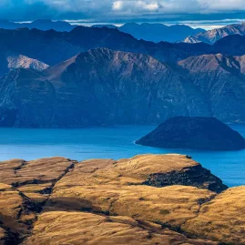 Elevated view of Mou Waho Island on Lake Wanaka with mountains in the background