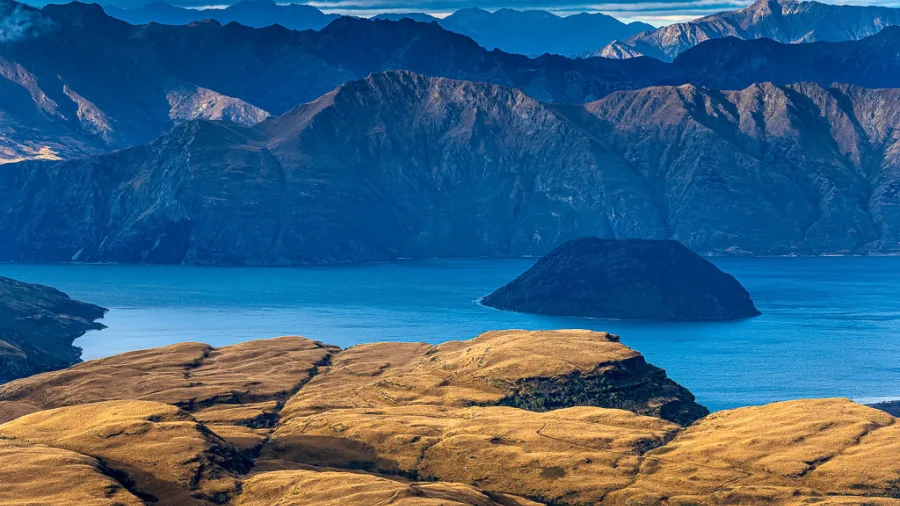 Elevated view of Mou Waho Island on Lake Wanaka with mountains in the background