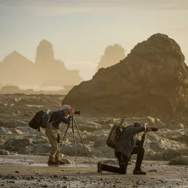 Photographers shooting sea stacks on West Coast beach