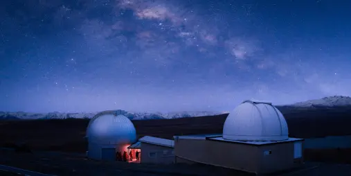 Observatory buildings under bright Milky Way sky at Mount John