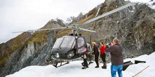 Guests boarding helicopter on Franz Josef Glacier