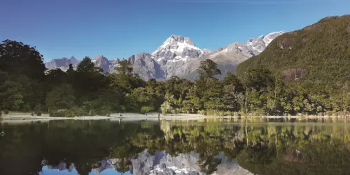 Snow-capped Mt Madeline reflected in the still waters of Lake Alabaster