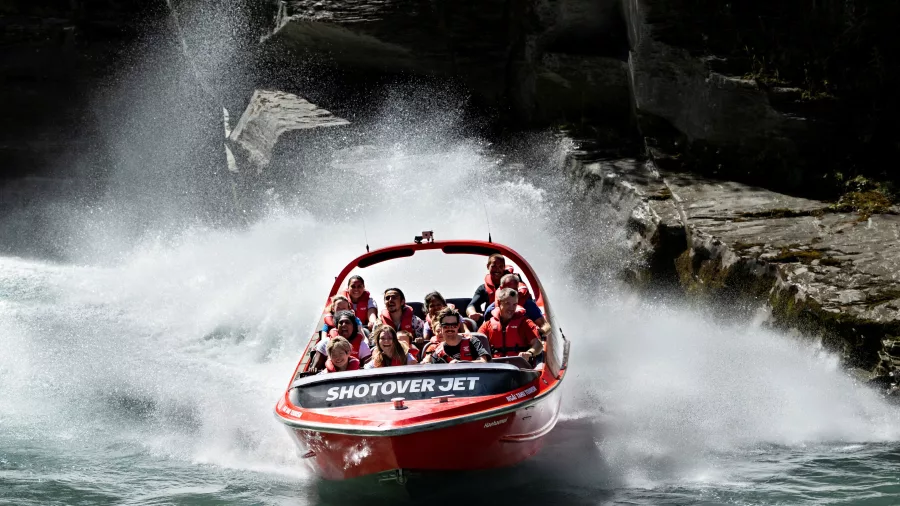 Shotover Jet speeding through canyon with water spray