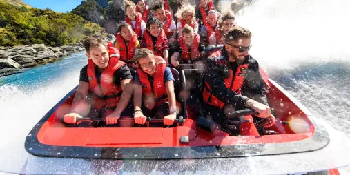 Smiling passengers on Shotover Jet boat ride