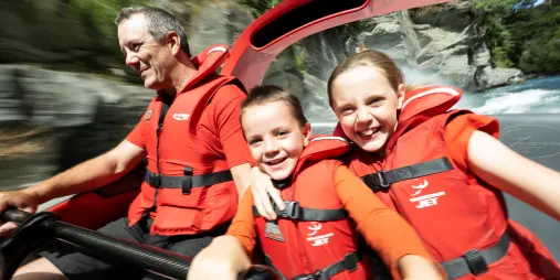 Father and two children on Shotover Jet ride in Queenstown