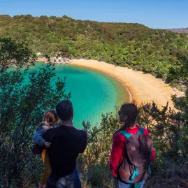 Family enjoying a scenic lookout over Anchorage Bay in Abel Tasman National Park