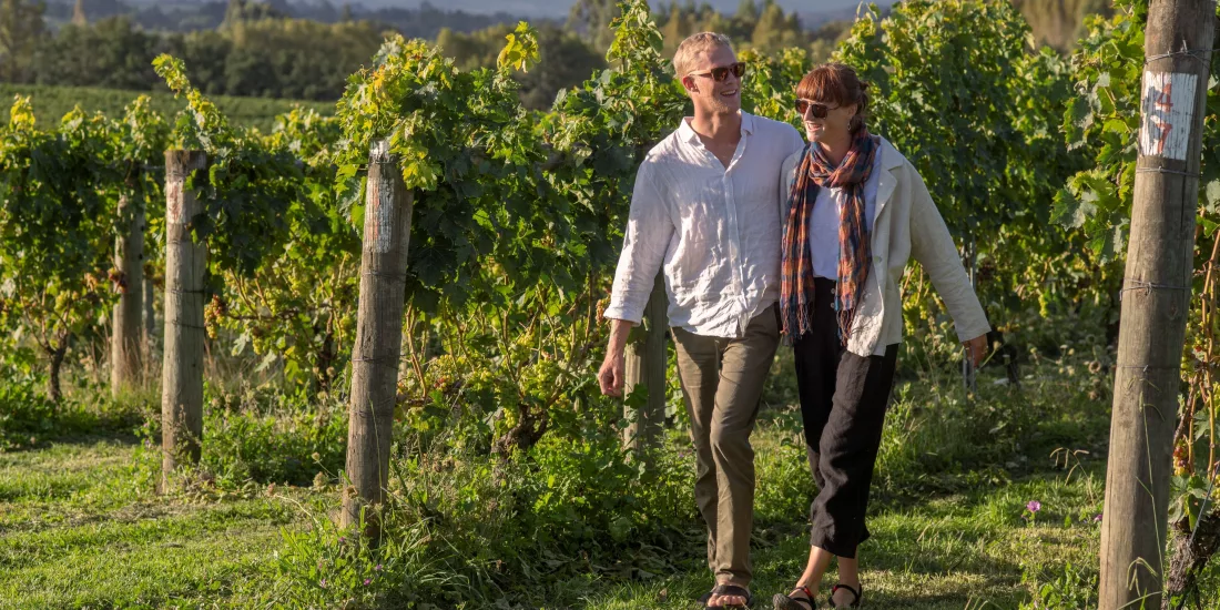 Couple walking through the vines at Heaphy Vineyard & Winery in Nelson Tasman