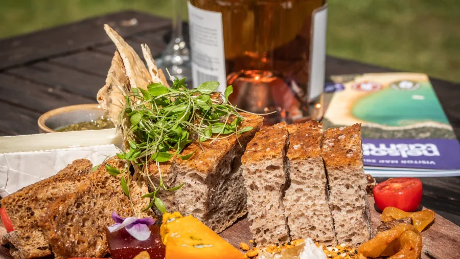 Artisan food platter and wine outdoors at Gravity Winery, Upper Moutere