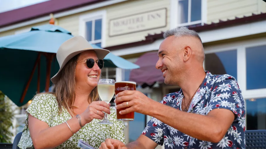 Couple enjoying drinks outside the historic Moutere Inn in Nelson Tasman