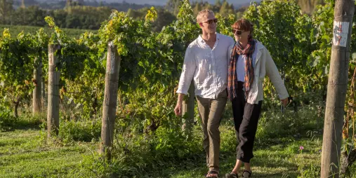 Couple walking through the vines at Heaphy Vineyard & Winery in Nelson Tasman