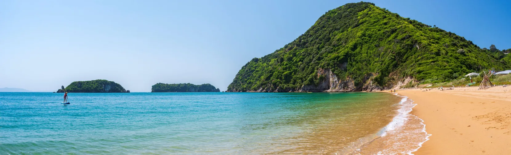 Golden sand shoreline and clear water at Tata Beach, Golden Bay