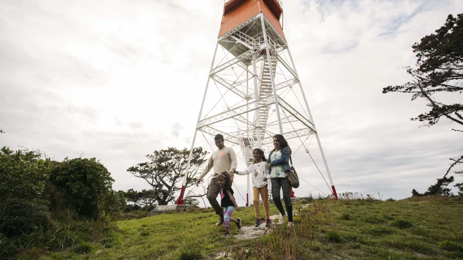 Family walking near the lighthouse at Farewell Spit, Nelson Tasman