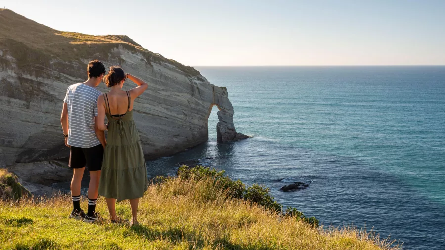 Couple admiring the view from Cape Farewell, Golden Bay