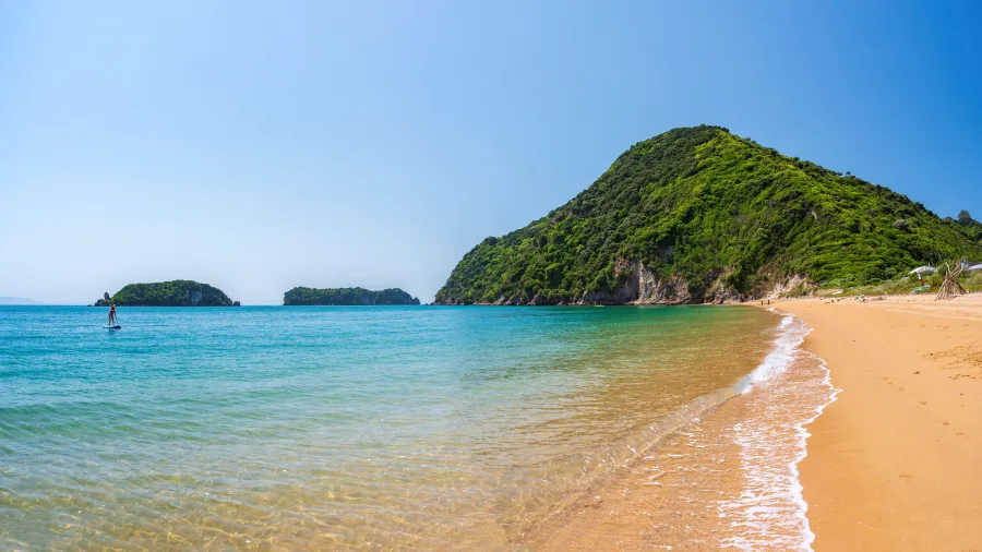 Golden sand shoreline and clear water at Tata Beach, Golden Bay