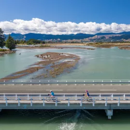 Cyclists crossing bridge over Mapua Estuary on the Great Taste Trail