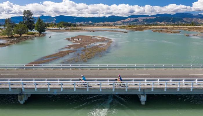 Cyclists crossing bridge over Mapua Estuary on the Great Taste Trail