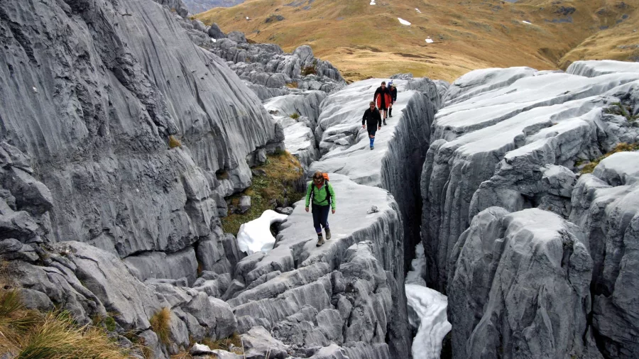 Hikers exploring limestone formations in Kahurangi National Park, Nelson Tasman