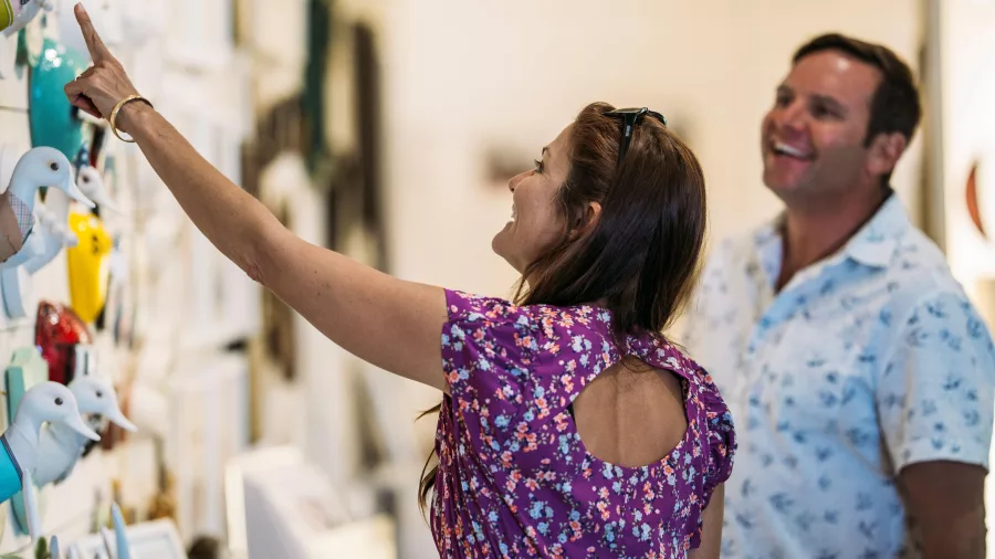 Couple browsing Cools Art Gallery at Mapua Wharf in Nelson Tasman