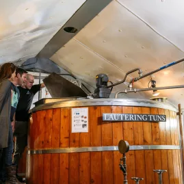 Visitors learning about a traditional lauter tun at McCashins Craft Brewery in Nelson New Zealand