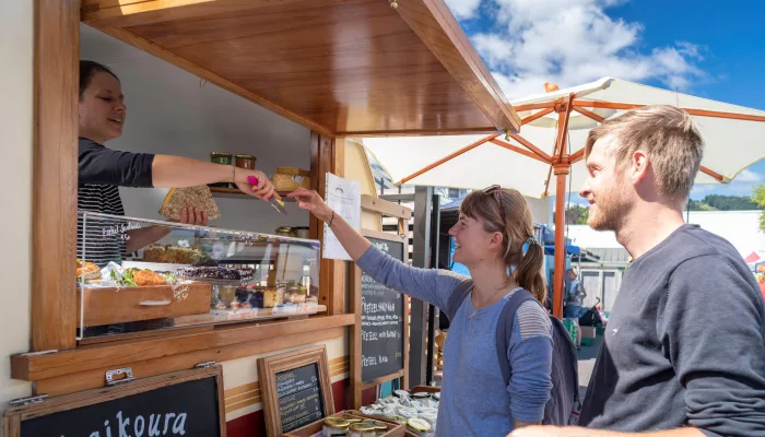 Couple buying food at Nelson Farmers Market in New Zealand
