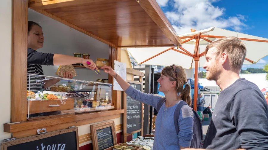 Couple buying food at Nelson Farmers Market in New Zealand