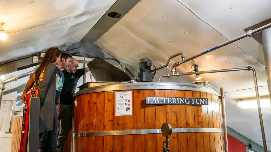 Visitors learning about a traditional lauter tun at McCashins Craft Brewery in Nelson New Zealand