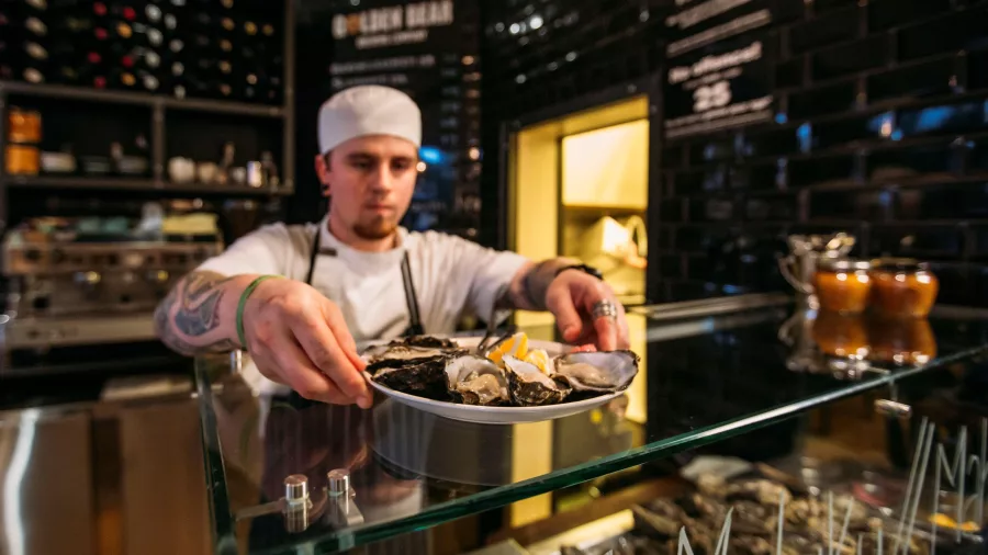 Chef preparing fresh mussels at Urban Bar & Eatery in Nelson New Zealand