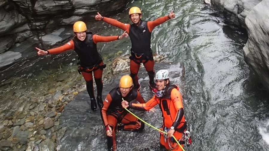 Group of canyoners smiling and giving thumbs up in Doom Creek canyon