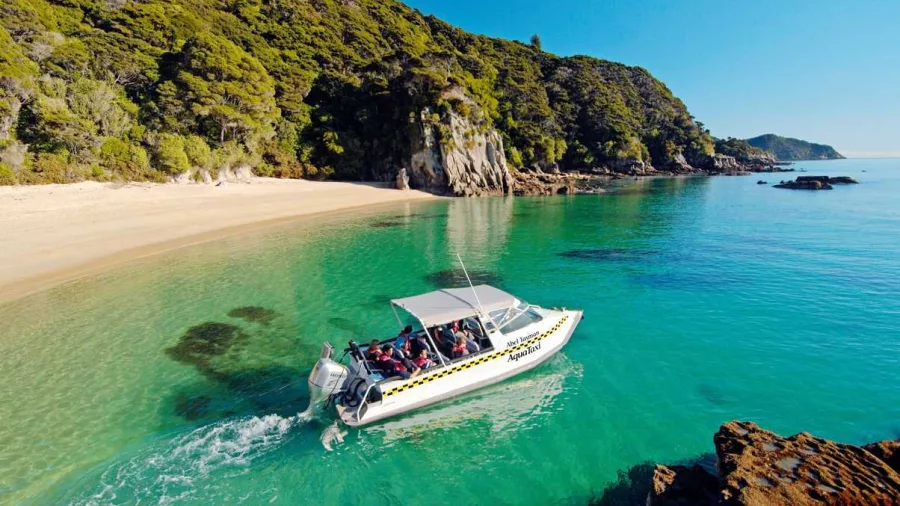 Water taxi cruising along the Abel Tasman coastline near Torrent River