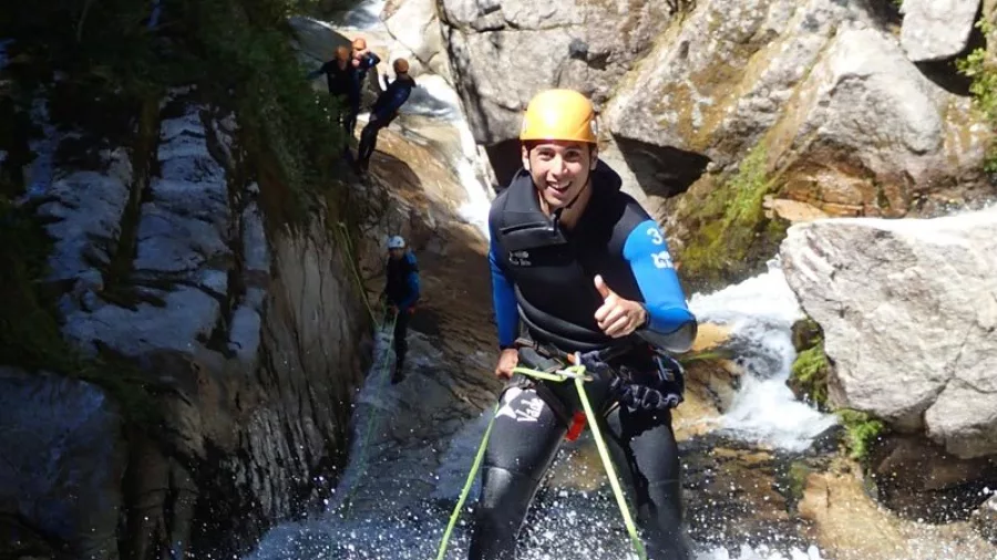 Canyoner giving a thumbs-up while descending a waterfall in Waterfall Creek canyon