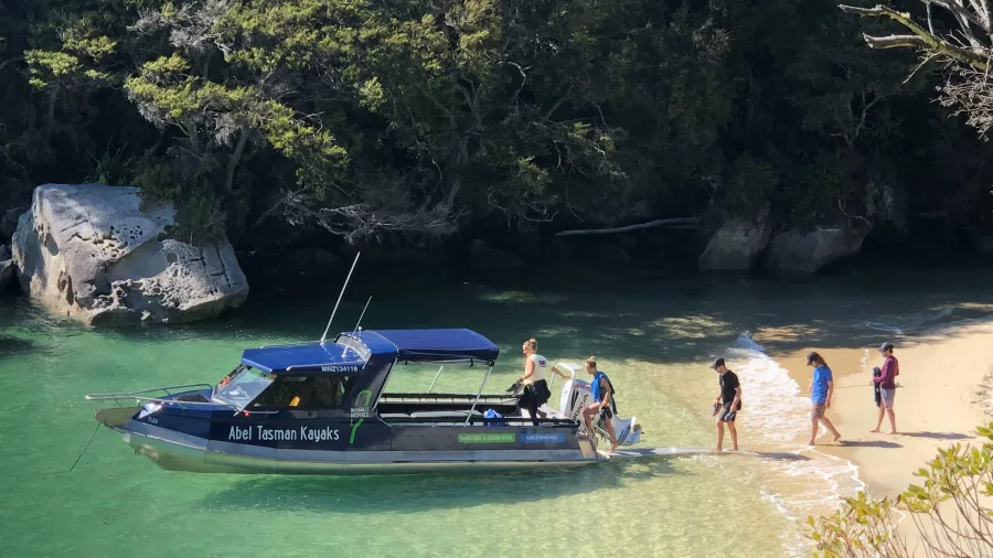 Travellers embarking a water taxi at Medlands Beach in Abel Tasman National Park