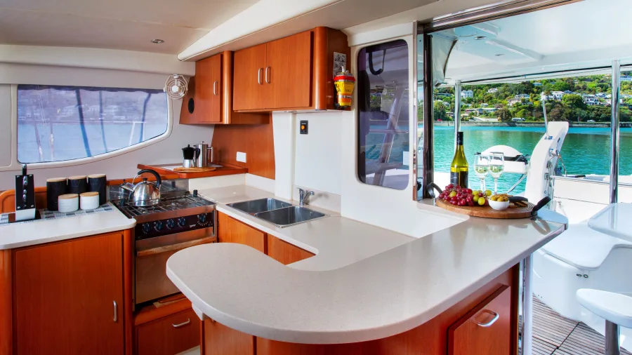 Modern catamaran galley kitchen with scenic view across the bay