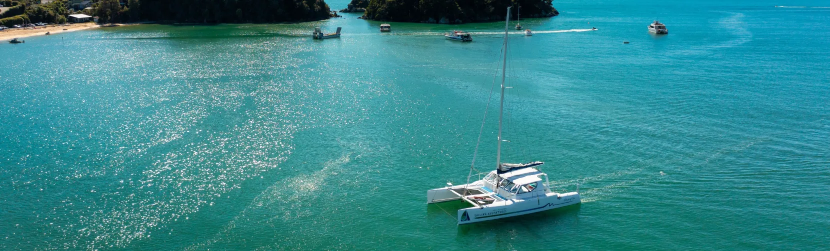 Catamaran moored near Kaiteriteri with coastal islands in the background