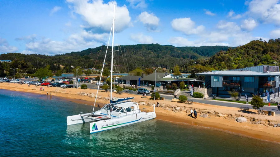 Catamaran docked at Kaiteriteri Beach ready for Abel Tasman sailing tour