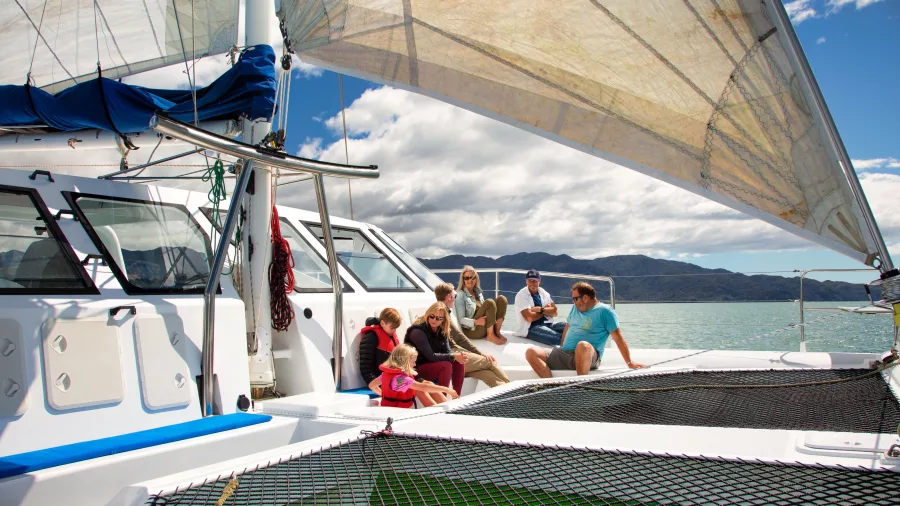 Families and groups enjoying the deck space on an Abel Tasman catamaran