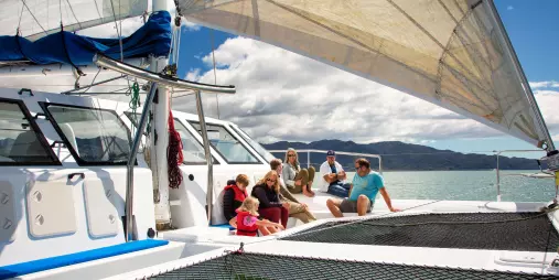 Families and groups enjoying the deck space on an Abel Tasman catamaran