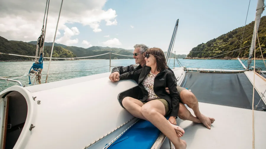 Older couple relaxing together on catamaran deck during Abel Tasman sailing tour