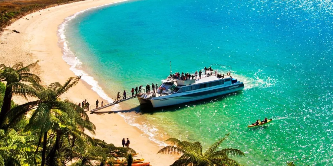 Crusader Sea Shuttle disembarking passengers at Onetahuti Beach in Abel Tasman National Park