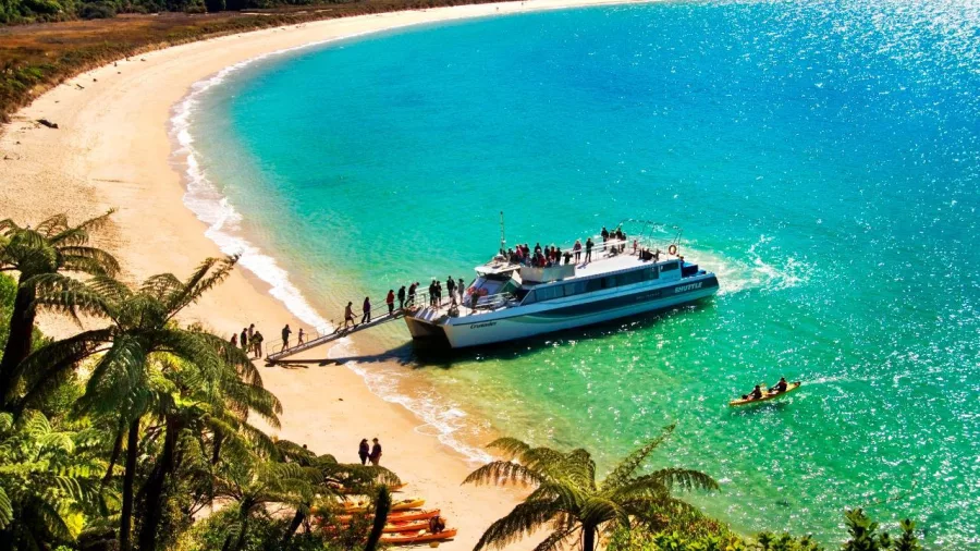 Crusader Sea Shuttle disembarking passengers at Onetahuti Beach in Abel Tasman National Park