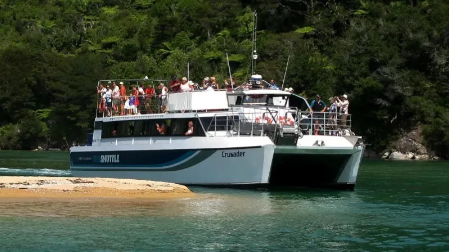 Crusader Abel Tasman Sea Shuttle arriving near Falls River with passengers on board
