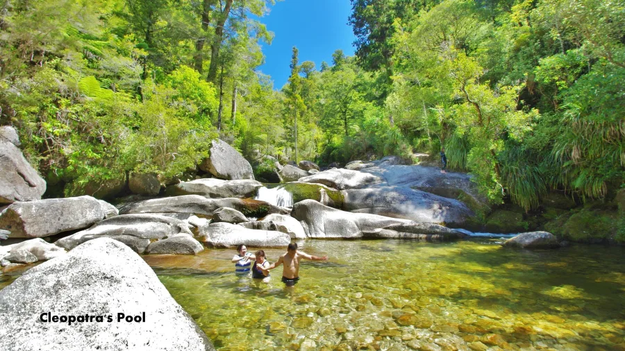 Visitors swimming in Cleopatra’s Pools at the base of the Torrent River in Abel Tasman National Park