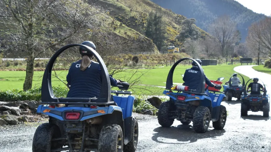 Guides lead a group ATV ride at Cable Bay Adventure Park’s Bayview Circuit with scenic hill views.