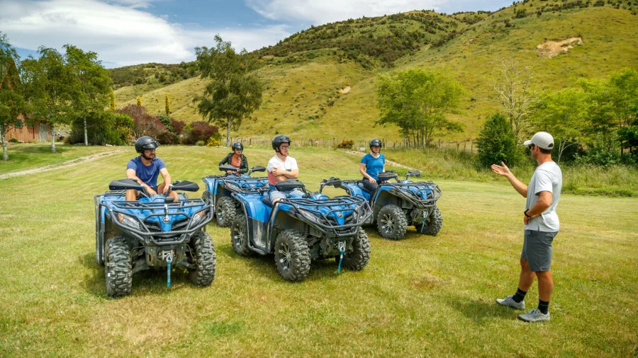 A guide giving a quad bike safety briefing to riders at the grassy base of the Bayview Circuit at Cable Bay Adventure Park, Nelson.