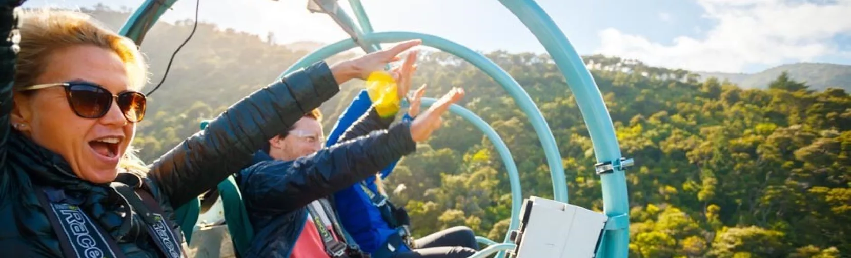 Riders enjoying the Skywire adventure on a sunny day at Cable Bay Adventure Park in Nelson