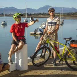 Cycling family relaxing by the waterfront on the Great Taste Trail